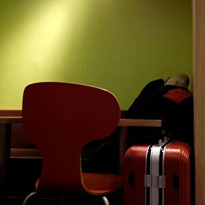 A man sleeps inside a McDonalds restaurant at midnight hours in Hong Kong