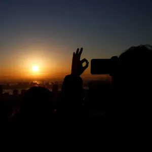 A man takes picture of the first sunrise on New Years Day at Roppongi Hills observation