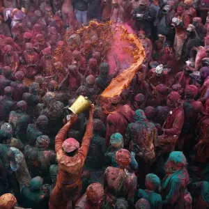 A man throws coloured water as he celebrates Lathmar Holi at Nandgaon A man throws coloured water as he celebrates Lathmar Holi at Nandgaon
