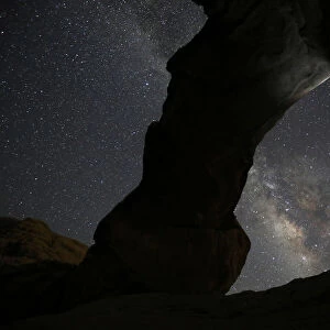 A man watches the stars seen on the sky of Al-Kharza area of Wadi Rum in the south of