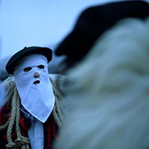 A masked man wearing a Basque beret takes part in carnival celebrations in Alsasua
