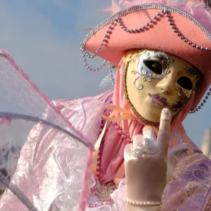 A masked reveller poses during the Venice Carnival