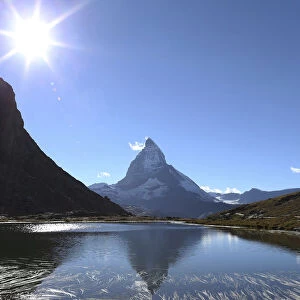 The Matterhorn mountain is reflected in the lake Riffel near Zermatt