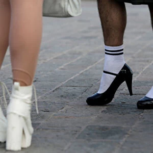 Member of the LGBT community stand with their high heels on before taking part in a race