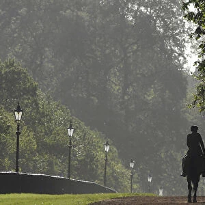 Members of the Household Cavalry are seen riding in the early morning in Hyde Park in