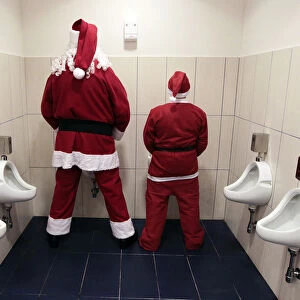 Two men dressed as Santa Claus use a toilet in Citta Sant Angelo near Pescara