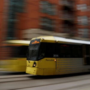 A Metrolink tram travels through the centre of Manchester