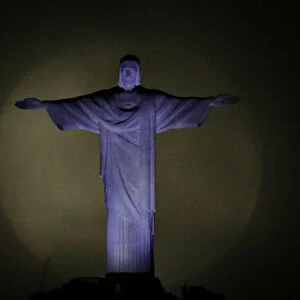 The moon is pictured behind the Christ the Redeemer statue ahead of the visit of Pope