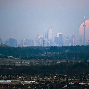 The moon rises over the Toronto city skyline as seen from Milton, Ontario