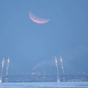 The moon is seen above a bridge of the Western Rapid Diameter motorway in St. Petersburg