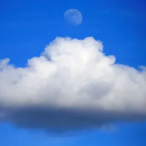 The moon is seen over a cumulus cloud in the skies over Avesnes-Lez-Aubert The moon is seen over a cumulus cloud in the skies over Avesnes-Lez-Aubert