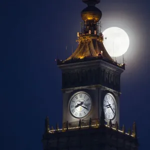 The moon is seen above the Palace of Culture and Science in the center of Warsaw The moon is seen above the Palace of Culture and Science in the center of Warsaw