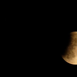 The moon is seen during a partial lunar eclipse in Venice