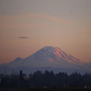 Mount Rainier is pictured as the last rays of sunlight hit its western side, taken