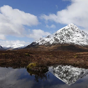 The mountain Buachaille Etive Mor is reflected in water near Ballachulish, Scotland