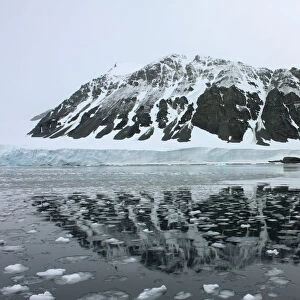 Mountain is reflected in a bay that used to be covered by the Sheldon glacier on the