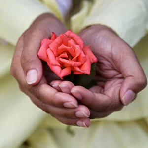 A Muslim boy holds a rose after offering Eid al-Fitr prayers marking the end of the