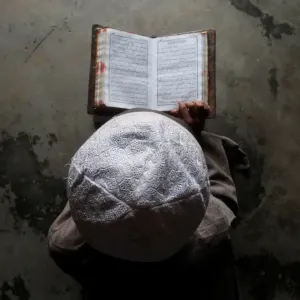 A Muslim boy learns to read the Koran at a madrassa, or religious school, during A Muslim boy learns to read the Koran at a madrassa, or religious school, during