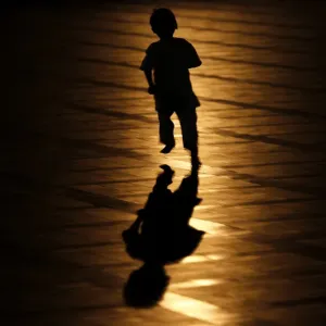 A muslim child runs after a mass prayer session marking the beginning of Ramadan