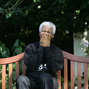 Nelson Mandela laughs with journalists and performers