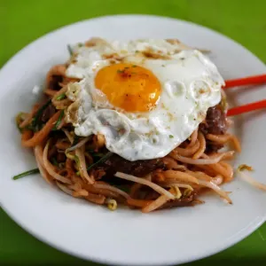 Noodle with egg is seen on a table along a street during breakfast in Phnom Penh Noodle with egg is seen on a table along a street during breakfast in Phnom Penh