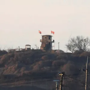 A North Korean flag flutters on the top of their guard post inside North Korean territory A North Korean flag flutters on the top of their guard post inside North Korean territory