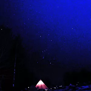 Norwegians sit next to their tent after the first day of the Ski-Flying World