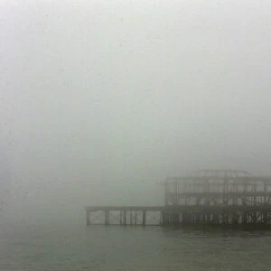 The old west pier is seen on a foggy day in Brighton