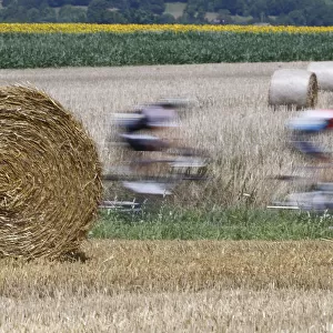 The pack of riders cycles on its way during the 197. 5km 13th stage of the Tour de France