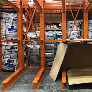 Partially empty shelves for plywood are seen at a Home Depot store ahead of the arrival