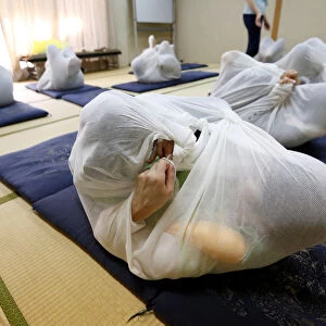 Participants perform Otonamaki, which translates as adult wrapping