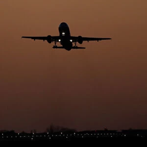A passenger plane takes off over London