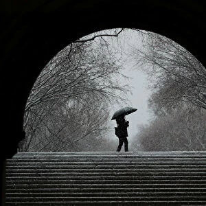 A pedestrian walks through Central Park during a snow storm in New York