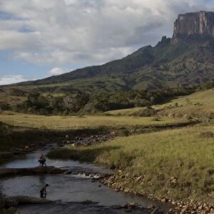 People bathe on the Tec river as they are on the road to Mount Roraima, near Venezuela s