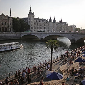 People enjoy the sun as Paris Beach opens along the banks of River Seine in Paris