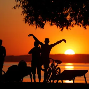 People enjoy sunset at a lake on the outskirts of Minsk People enjoy sunset at a lake on the outskirts of Minsk