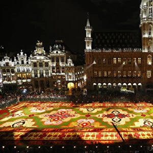 People gather around a giant flower carpet at Brussels Grand Place