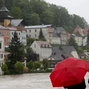 People look at flooded houses after heavy rainfall in the small Austrian city of Steyr People look at flooded houses after heavy rainfall in the small Austrian city of Steyr
