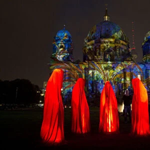 People look at a light installation during the opening day of the Festival of Light