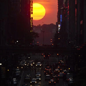 People make their way through 42nd street at sunset, during the Manhattanhenge in