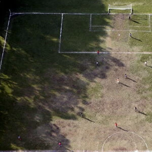 People play soccer in an amateur soccer field in Sao Paulo