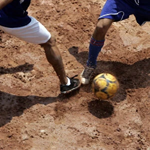 People practice soccer in a slum on outskirts of Sao Paulo