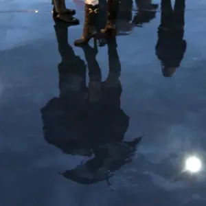 People are reflected on the floor illuminated with LED lights during the inauguration of People are reflected on the floor illuminated with LED lights during the inauguration of
