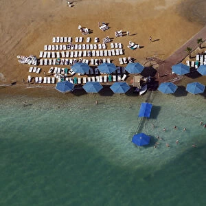 People sunbathe at a public beach in this aerial view of the Dead Sea