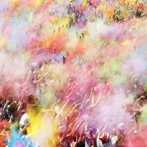 People throw coloured powder during the Holi festival in Barcelona