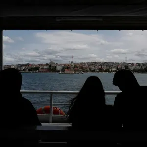 People travel on a ferry over the Bosphorus in Istanbul People travel on a ferry over the Bosphorus in Istanbul