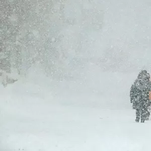 People walk during heavy snowfall in Claviere