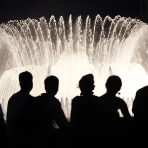 People watch the Font Magica de Montjuic (Magic Fountain of Montjuic) show in Barcelona People watch the Font Magica de Montjuic (Magic Fountain of Montjuic) show in Barcelona