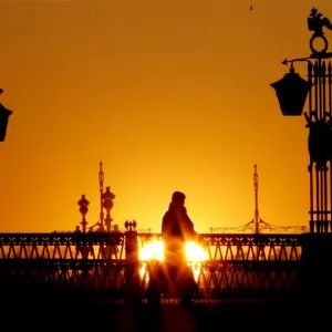 A person walks across a bridge in central St Petersburg