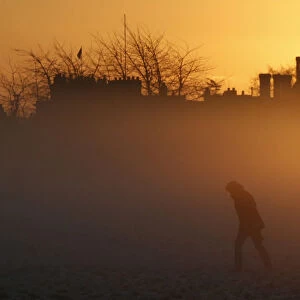 A person walks during sunrise in Knutsford